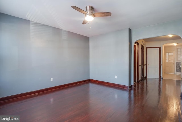 spare room with ceiling fan and dark hardwood / wood-style floors