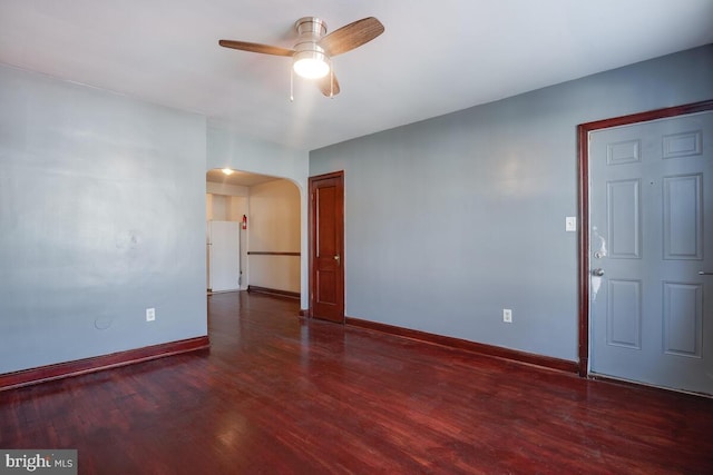 spare room with ceiling fan and dark hardwood / wood-style flooring