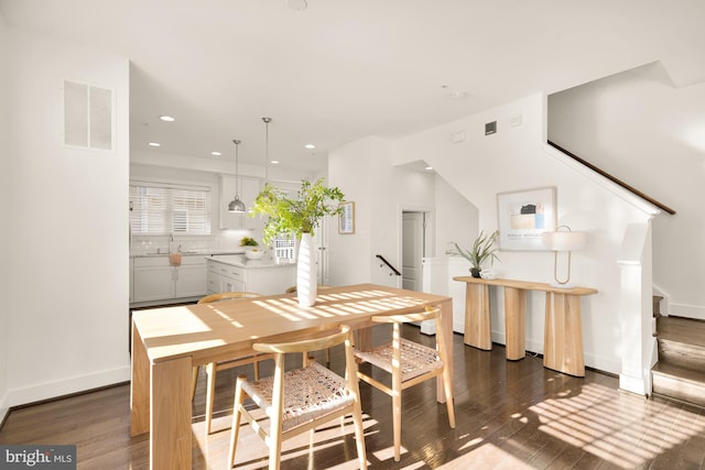 dining room featuring sink and dark hardwood / wood-style floors