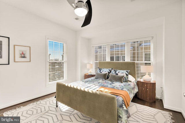 bedroom with ceiling fan and dark hardwood / wood-style flooring