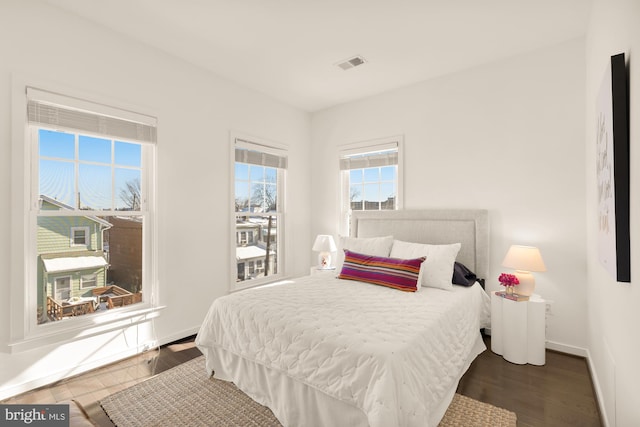 bedroom with dark wood-type flooring