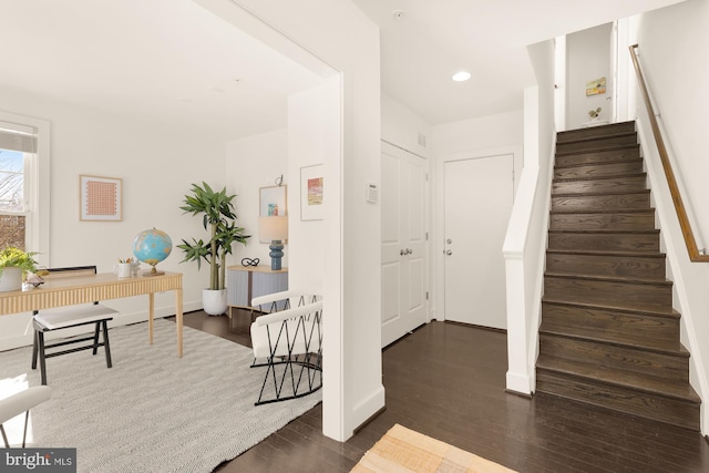 stairs featuring hardwood / wood-style floors