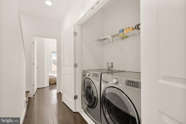 clothes washing area featuring dark hardwood / wood-style floors and independent washer and dryer