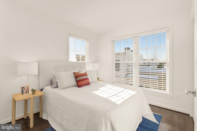 bedroom with dark hardwood / wood-style flooring