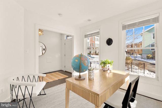 dining area featuring plenty of natural light and wood-type flooring