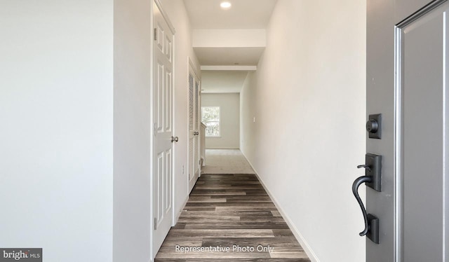 hallway with dark hardwood / wood-style flooring