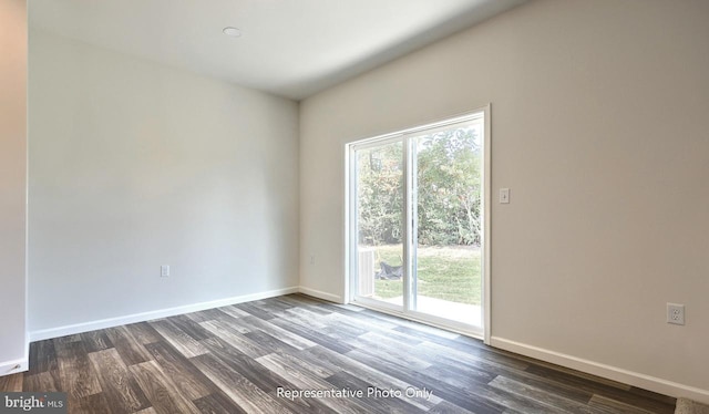 spare room with dark wood-type flooring