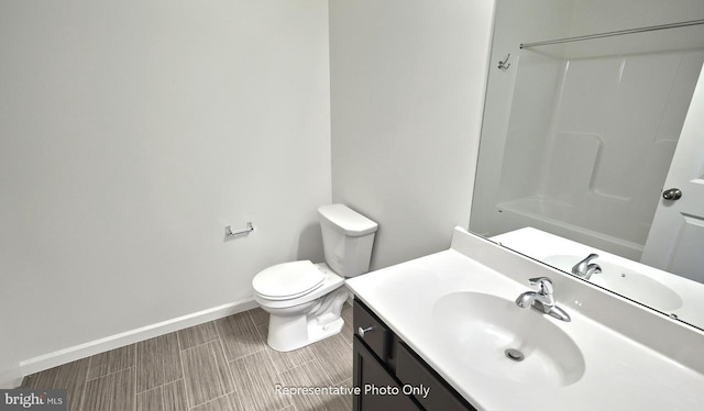 bathroom featuring vanity, toilet, and walk in shower