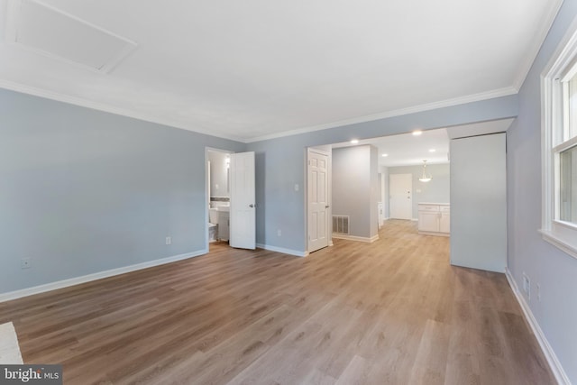 interior space featuring crown molding and light wood-type flooring