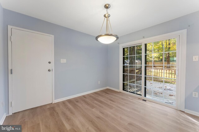 unfurnished dining area with light hardwood / wood-style flooring