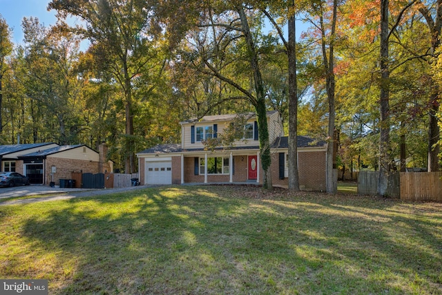 view of front of property with a front lawn and a garage