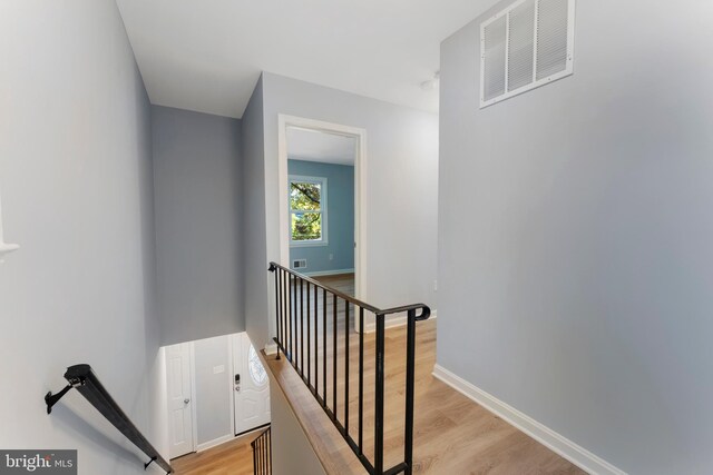 staircase with hardwood / wood-style floors