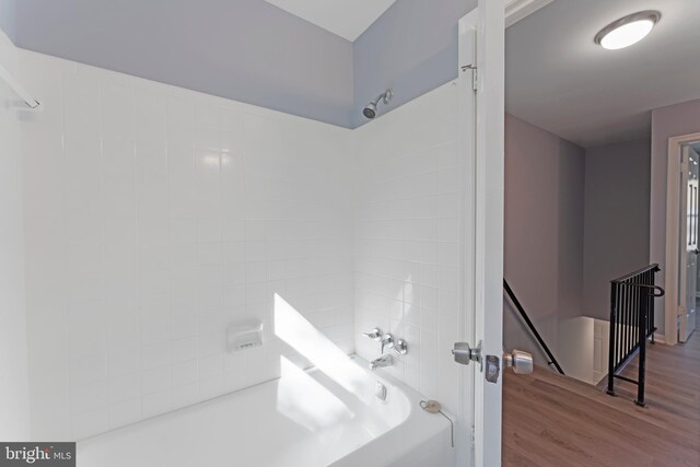 bathroom featuring shower / washtub combination and hardwood / wood-style flooring