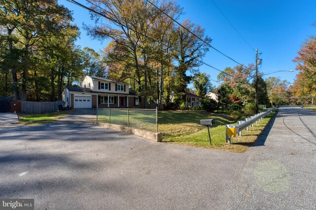 view of front facade with a front lawn and a garage