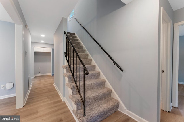 stairway with hardwood / wood-style flooring