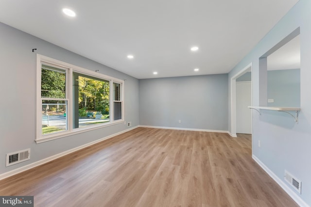 empty room with light hardwood / wood-style flooring