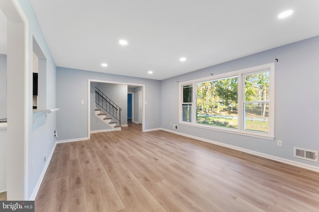 unfurnished living room featuring light wood-type flooring