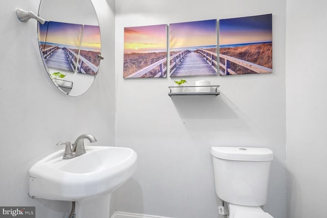 bathroom featuring toilet and sink