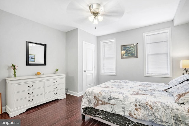 bedroom with dark hardwood / wood-style floors and ceiling fan