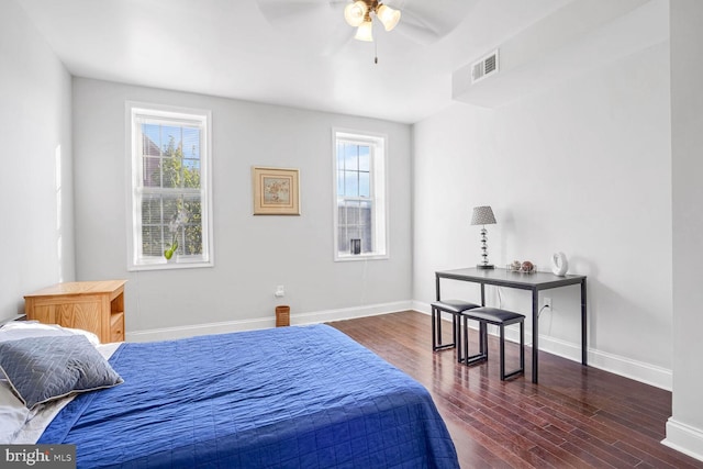 bedroom with multiple windows, dark hardwood / wood-style floors, and ceiling fan