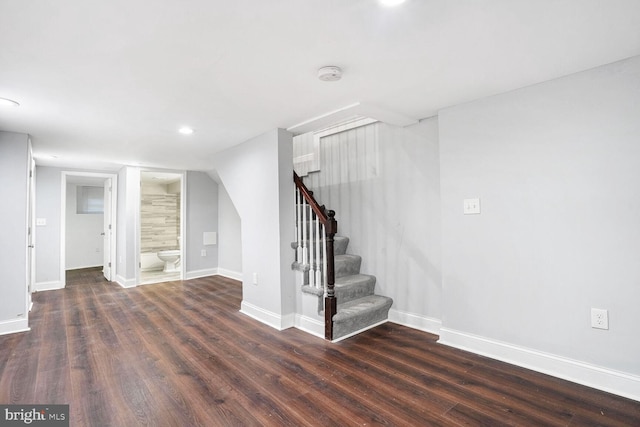 basement with dark hardwood / wood-style floors