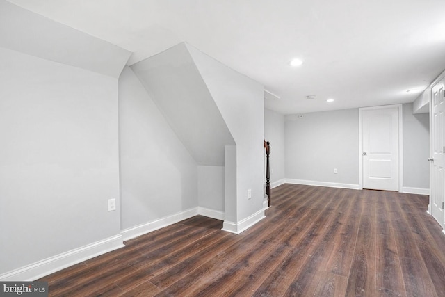 additional living space with dark hardwood / wood-style flooring