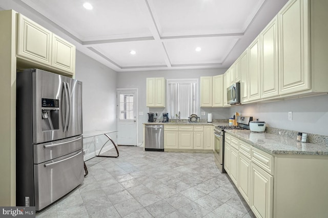 kitchen featuring appliances with stainless steel finishes, beamed ceiling, sink, light stone counters, and coffered ceiling