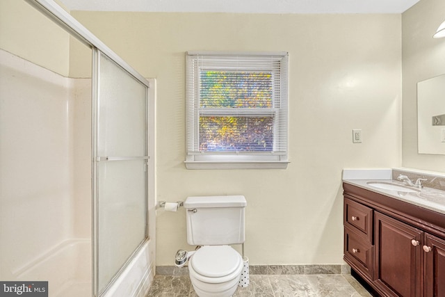 full bathroom featuring vanity, toilet, and enclosed tub / shower combo