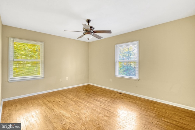 empty room featuring ceiling fan and light wood-type flooring