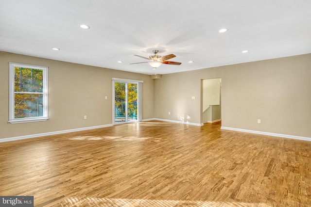 unfurnished room with light hardwood / wood-style flooring and ceiling fan