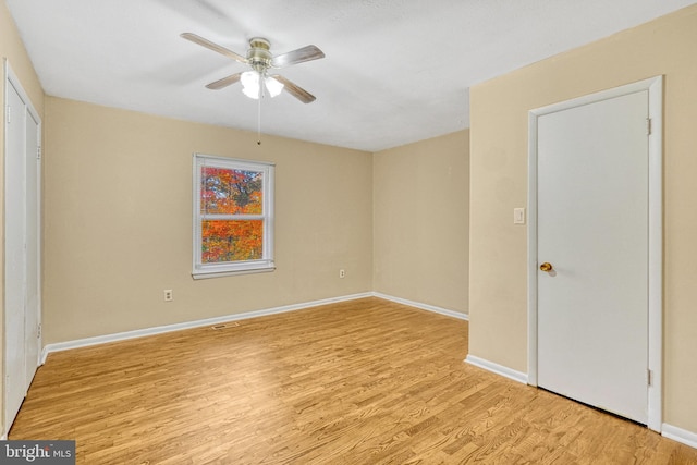 unfurnished room featuring light wood-type flooring and ceiling fan