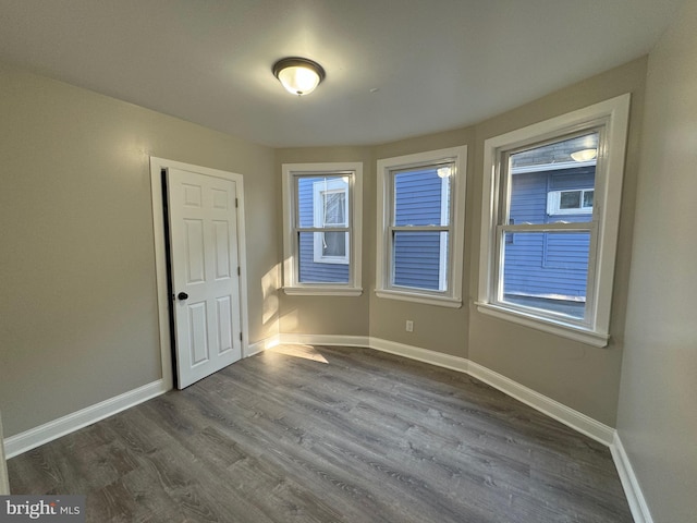 unfurnished room featuring dark hardwood / wood-style flooring