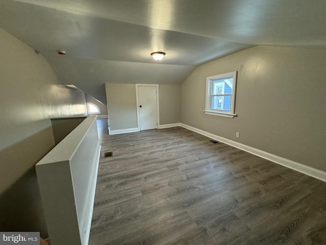 bonus room featuring wood-type flooring and vaulted ceiling