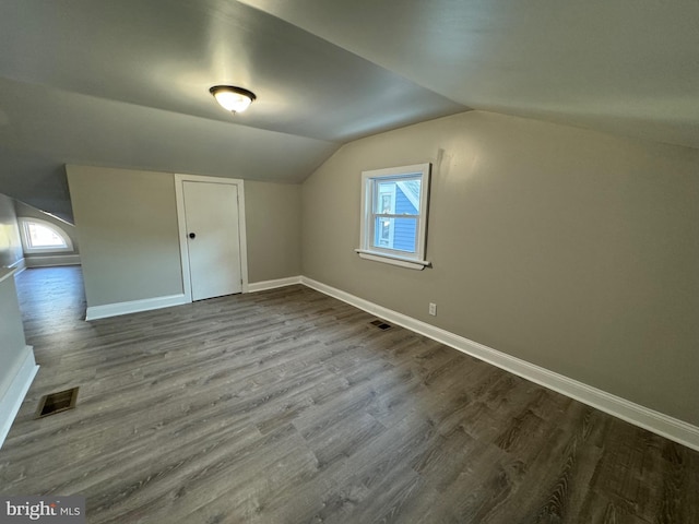 additional living space featuring lofted ceiling and hardwood / wood-style flooring