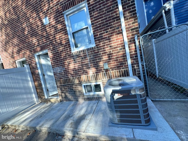 exterior space featuring central air condition unit and a patio