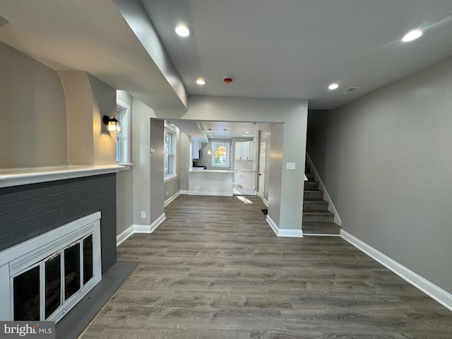 unfurnished living room with a fireplace and hardwood / wood-style floors