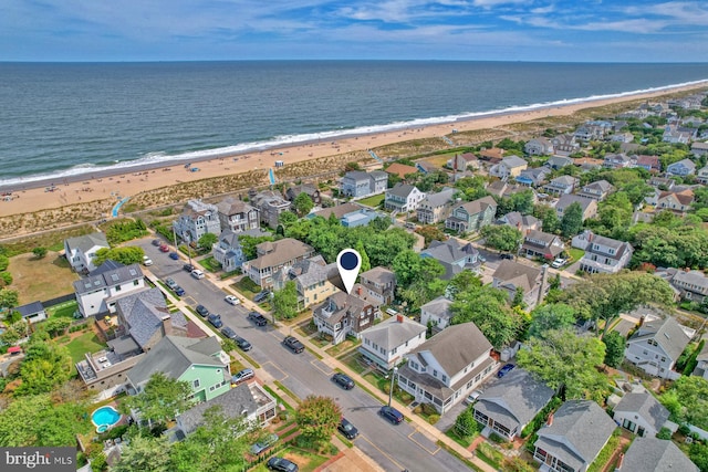 birds eye view of property with a view of the beach and a water view