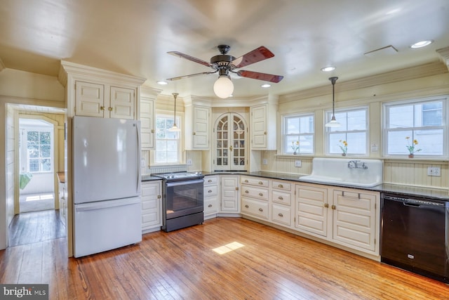 kitchen featuring black dishwasher, stainless steel range with electric cooktop, light wood-type flooring, sink, and white refrigerator