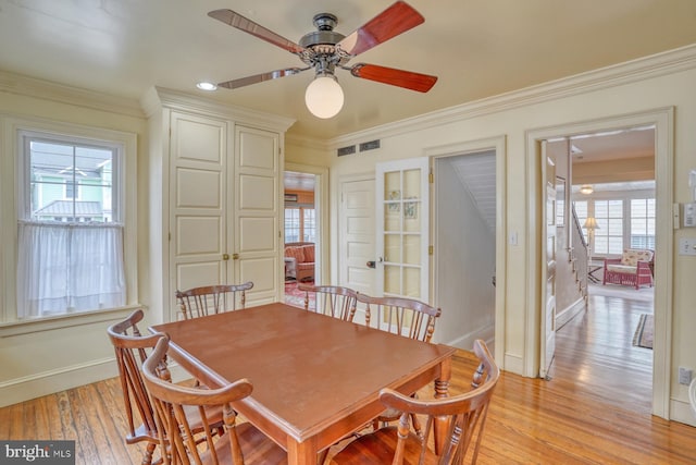 dining area with ornamental molding, light hardwood / wood-style flooring, and ceiling fan