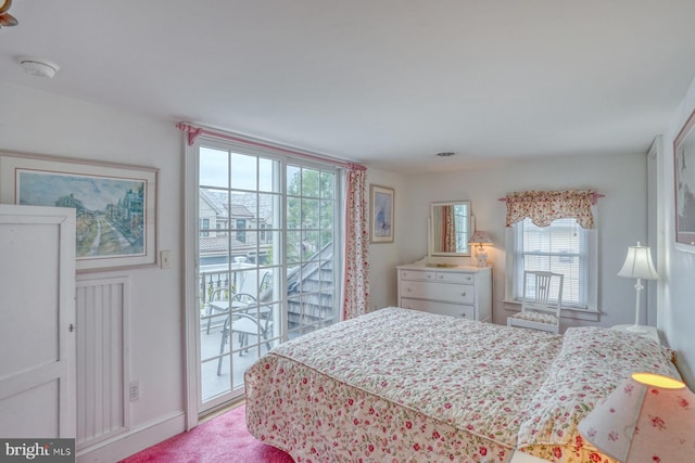 carpeted bedroom featuring access to outside