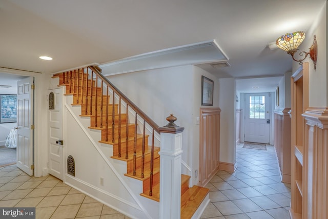 stairway featuring tile patterned flooring