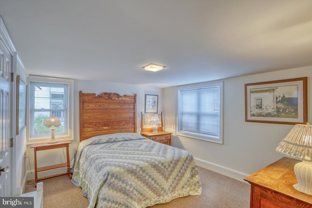 bedroom featuring light colored carpet