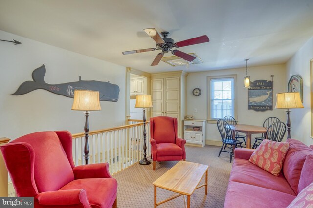 carpeted living room featuring ceiling fan