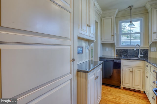 kitchen featuring light wood-type flooring, dishwasher, dark stone countertops, pendant lighting, and sink