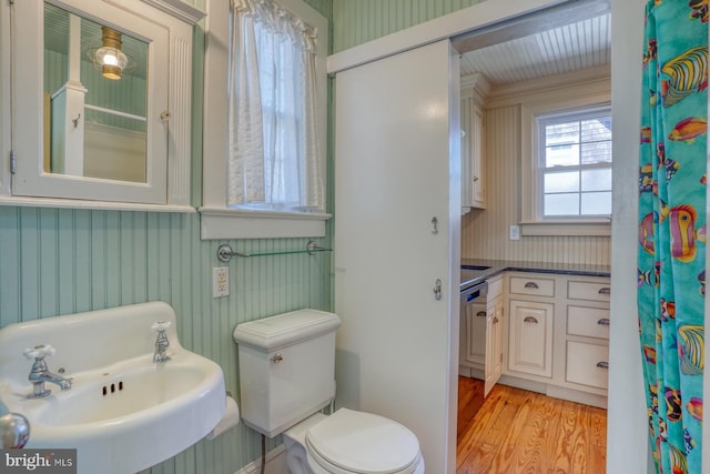 bathroom with sink, hardwood / wood-style flooring, and toilet