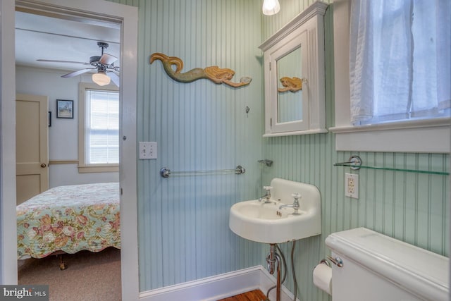 bathroom featuring toilet and ceiling fan