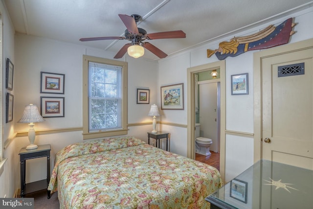 bedroom featuring connected bathroom, ceiling fan, ornamental molding, and wood-type flooring