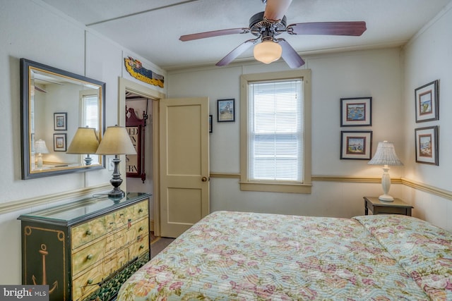 bedroom with a closet, crown molding, and ceiling fan