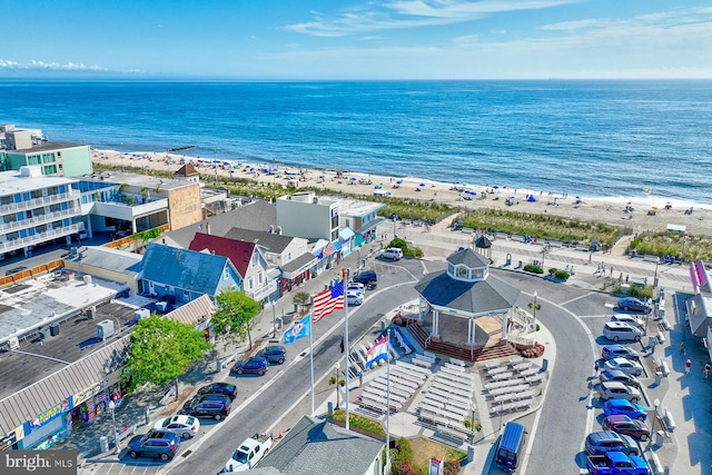 aerial view with a water view and a beach view