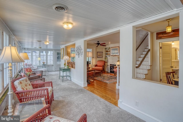 living room featuring light hardwood / wood-style floors and ceiling fan